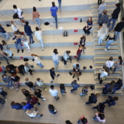 Students sitting and walking up staircase