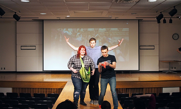 Sami Glass, Paul Dilyard and Ryan Phillips show off their creations on the runway at the University Innovation Fellows Kent State Regional Meetup. Photo by Laurie Moore.