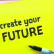 Marker and 'create your future' written on yellow paper