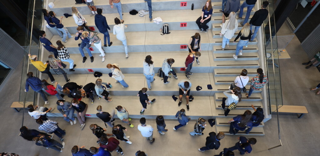 Students sitting and walking up staircase